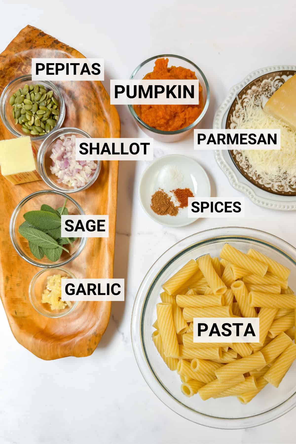 Ingredients for pumpkin sage pasta including spices, fresh sage, butter, canned pumpkin, shallots, and more.