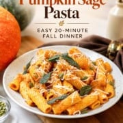Pinterest graphic for creamy pumpkin sage pasta with rigatoni in a pumpkin Parmesan sauce, topped with crispy sage, pepitas, black pepper, and grated cheese, labeled “Easy 20-Minute Fall Dinner.”