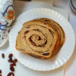Whole wheat cinnamon raisin swirl bread with a visible cinnamon spiral and raisins.