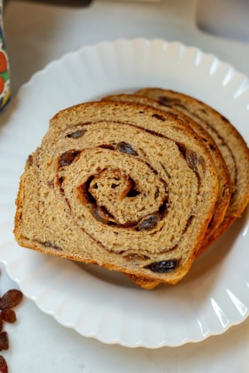 Whole wheat cinnamon raisin swirl bread with a visible cinnamon spiral and raisins.