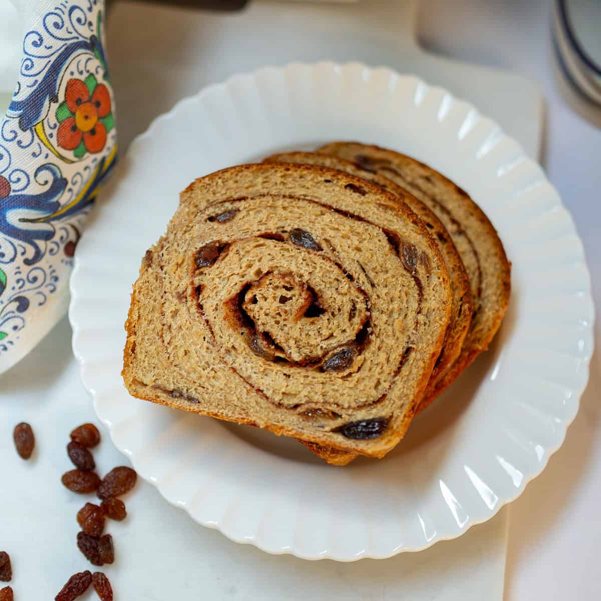 Whole wheat cinnamon raisin swirl bread with a visible cinnamon spiral and raisins.