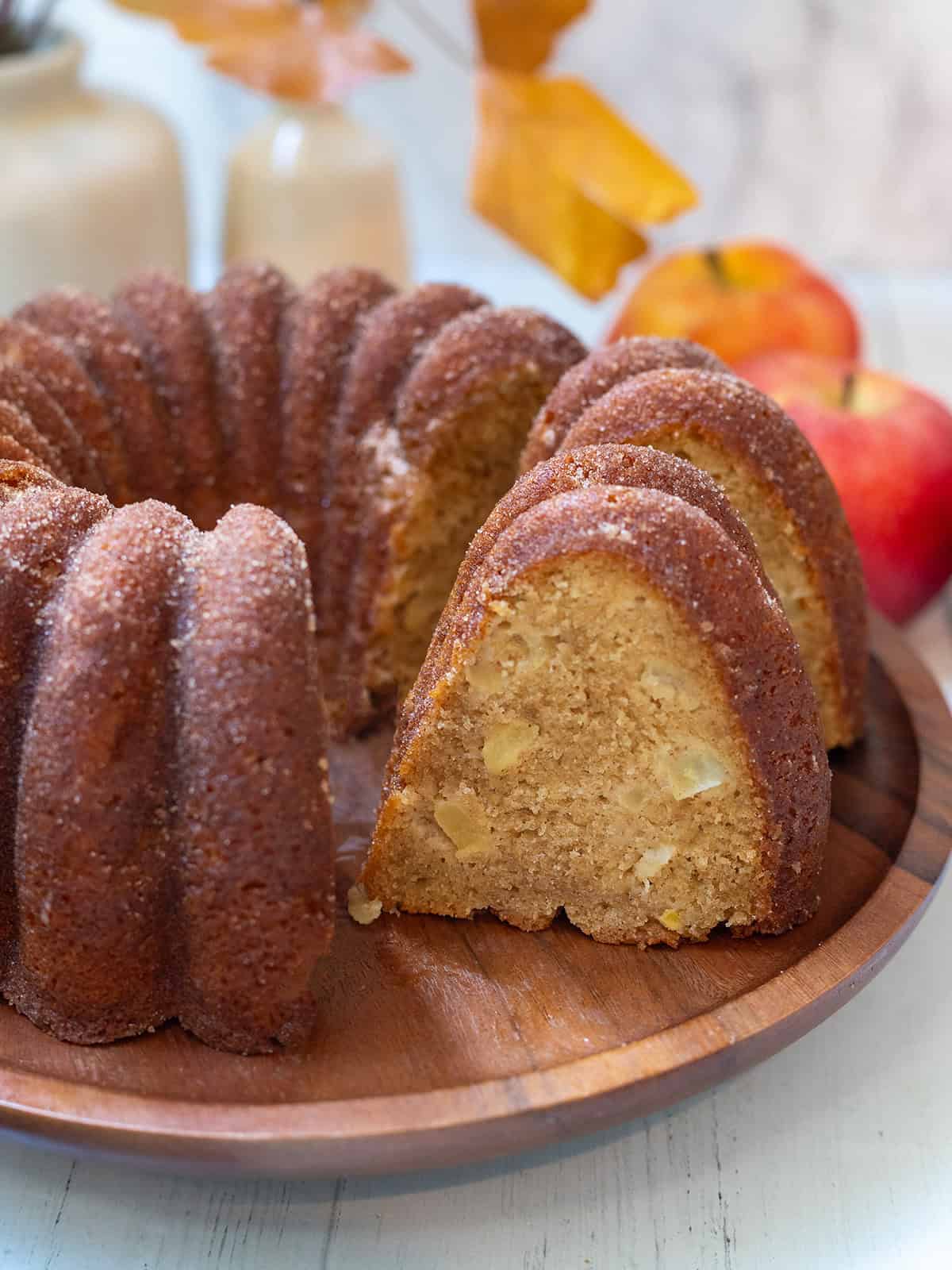 Close-up slice of apple cider Bundt cake showing a tender spiced crumb with small pieces of fresh apple.
