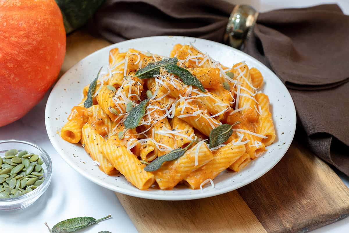 Pumpkin sage rigatoni in a creamy pumpkin Parmesan sauce topped with crispy sage, black pepper, pepitas, and freshly grated cheese.